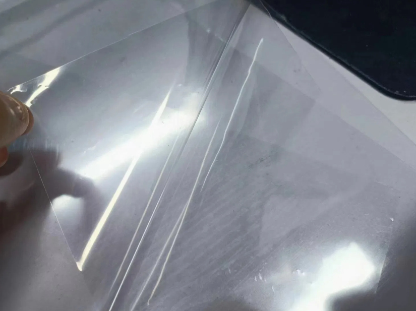 45 microns +/- self adhesive transparent laminating film with polyster release.